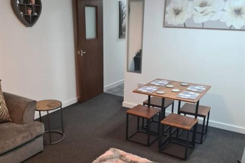 a living room with a table and chairs and a couch at Cosy Nook - Town centre flat with free nearby parking, in Shrewsbury