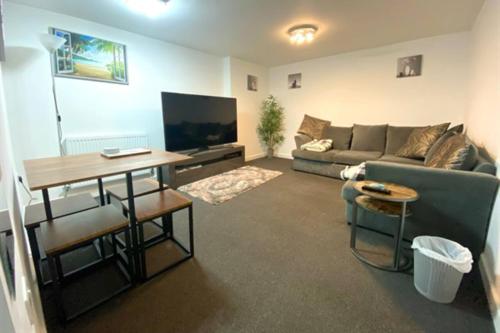 a living room with a couch and a table at Cosy Nook - Town centre flat with free nearby parking, in Shrewsbury