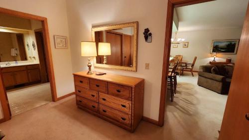 a living room with a dresser and a mirror at Southridge #20 in Harbor Springs