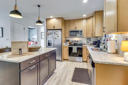 a kitchen with stainless steel appliances and wooden cabinets at 3 Blocks to Beach and Potomac River Virginia Escape in Colonial Beach