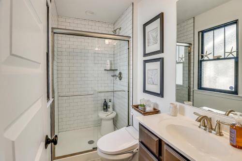 a white bathroom with a toilet and a sink at 3 Blocks to Beach and Potomac River Virginia Escape in Colonial Beach