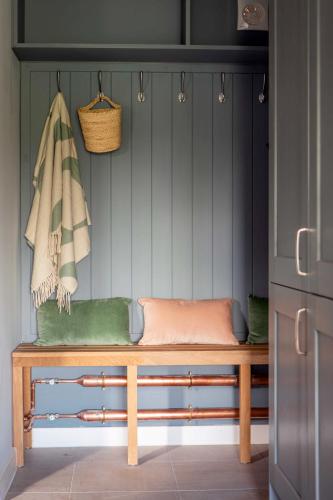 a bench in the corner of a kitchen at 1 Beechwood at Thoulstone Park in Westbury