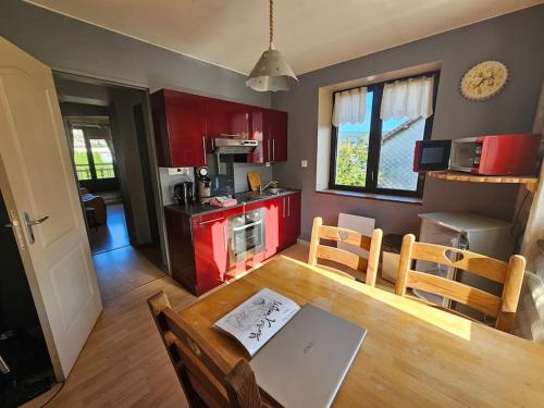une cuisine et une salle à manger avec une table et des chaises dans l'établissement Le tout en double, à Gérardmer