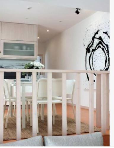 a dining room with a white table and white chairs at Beach Bungalows - Casal dos Patos - Vila Norte in Lourinhã