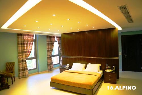 a bedroom with a large bed and a large window at Layali Al Shams Hotel in ‘Anjar