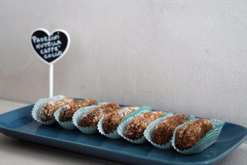 a blue plate with four donuts on a table at B&B Arco Dei Sogni in Celano