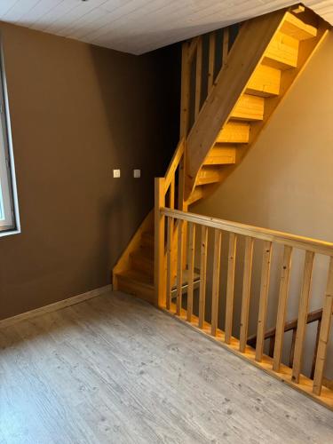 a room with a wooden staircase in a house at Gîte Le Tilleul in Le Tilleul