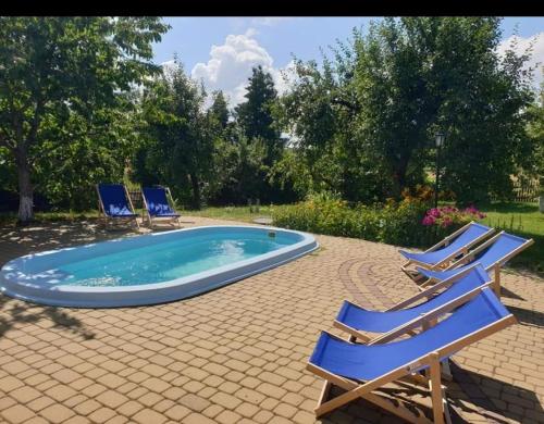 a group of chairs and a swimming pool at GOSPODARSTWO TURYSTYCZNE w OSINKACH in Suwałki