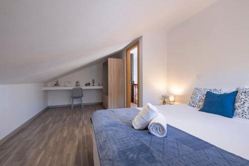 a bedroom with a bed with two pillows on it at Casa Almada in Ribeira Brava