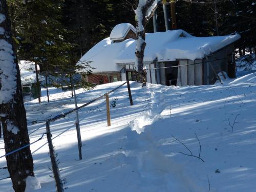 a fence covered in snow next to a house at Bed and Breakfast Du Repos in Saint Quentin