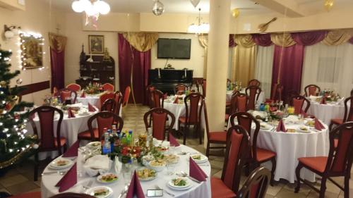a dining room with tables and a christmas tree at Hotel Relaks in Wola Ducka