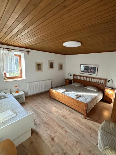 a bedroom with a bed and a wooden ceiling at Holiday house Pr Robč in Bovec
