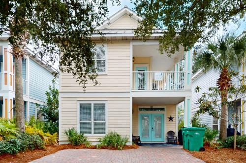 a white house with a blue door at Villages of Crystal Beach: Kono Cabana in Destin