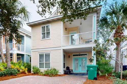 a large white house with a blue door at Villages of Crystal Beach: Kono Cabana in Destin