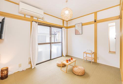 a living room with a large window and a table at sunrise 2 in Tokyo