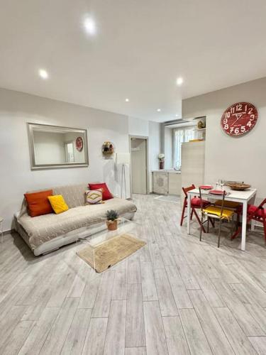 un salon avec un canapé et une table dans l'établissement Le Palmero Centre ville, plage, clim, à Menton