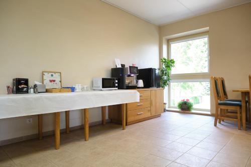 a kitchen with a counter and a counter top at Jono Pauliaus II piligrimu namai in Raseiniai