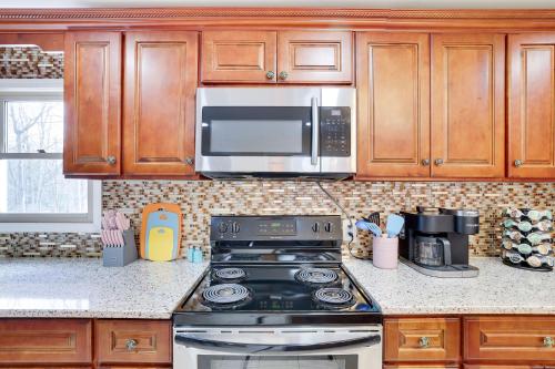 a kitchen with a stove and a microwave at 3BD Stevens Universe Theme - Games - Backyard in Tobyhanna