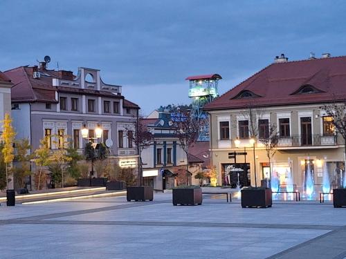 a city square with buildings and a clock tower at Klimatyczny apartament przy bocheńskim Rynku. in Bochnia
