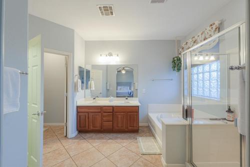 a bathroom with a tub and a sink and a shower at Pet friendly 3br 2ba Private optional heated Pool BBQ grill Golf Clubs close to park in Casa Grande