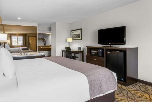 a hotel room with a bed and a flat screen tv at Best Western of Harbor Springs in Harbor Springs