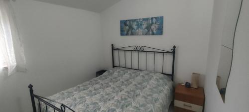 a bedroom with a bed and a picture on the wall at Tommaso Domus in Vasanello