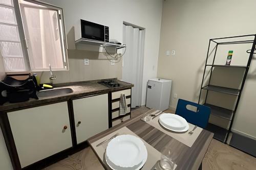 a small kitchen with a sink and a toilet in it at Residencial JC II sua casa em Belém do Pará in Belém