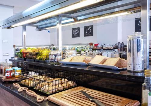 a kitchen with a counter with bread and other food at Hotel Zentral León in León