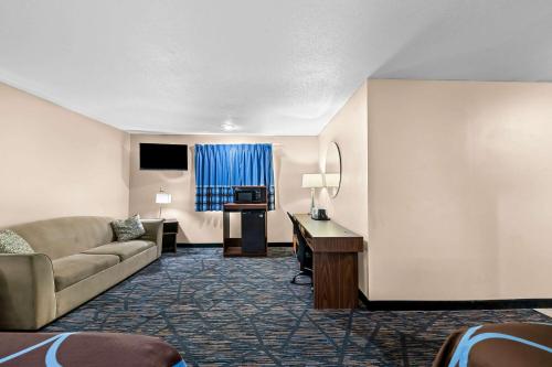 a hotel room with a couch and a desk at Super 8 by Wyndham Council Bluffs IA Omaha NE Area in Council Bluffs