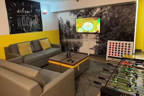 a living room with a couch and a tv at Super 8 by Wyndham Bloomington/Airport in Bloomington