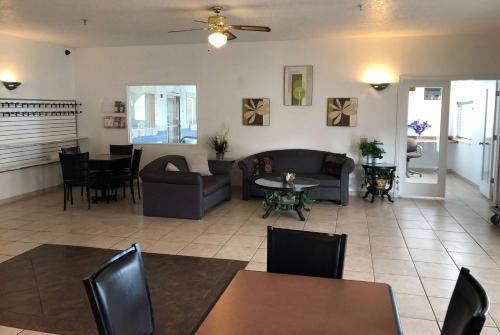 a living room with a couch and a table and chairs at Super 8 by Wyndham Price in Price