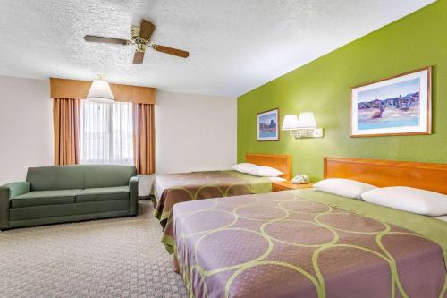 a hotel room with two beds and a couch at Super 8 by Wyndham Price in Price