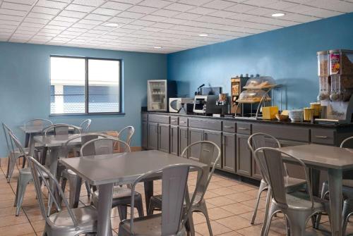 a restaurant with tables and chairs and a counter at Days Inn by Wyndham Neenah in Neenah