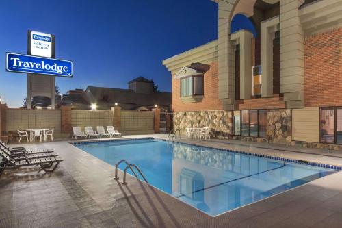 a pool at a hotel with a sign that reads travelodge at Travelodge by Wyndham Calgary South in Calgary