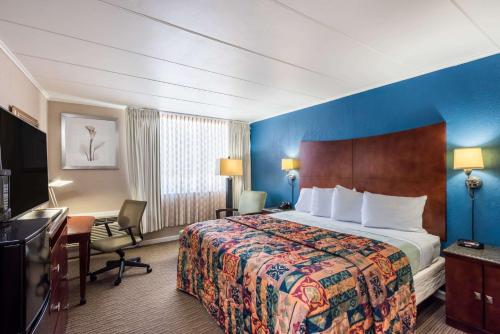 a hotel room with a bed and a desk at Travelodge by Wyndham Aberdeen in Aberdeen