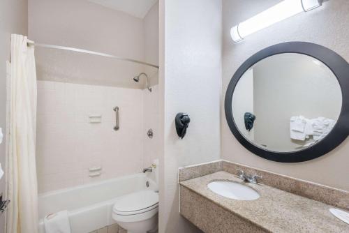 a bathroom with a sink and a toilet and a mirror at Travelodge by Wyndham Aberdeen in Aberdeen