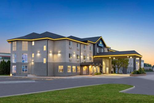 a large office building with a parking lot at Days Inn by Wyndham Steinbach in Steinbach
