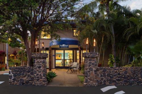 a building with a table and chairs in front of it at Days Inn by Wyndham Maui Oceanfront in Wailea