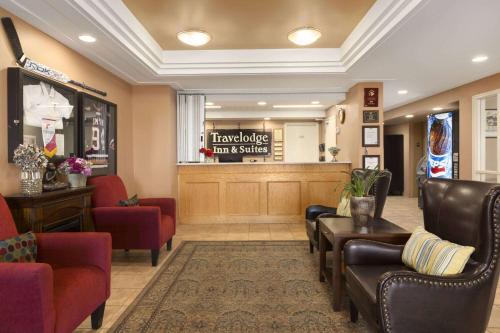 a waiting room with chairs and a hair salon at Travelodge by Wyndham Spruce Grove in Spruce Grove