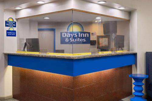 a day inn and suites counter with a window at Days Inn & Suites by Wyndham Albany in Albany