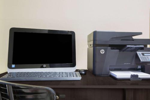a desk with a computer and a printer on it at Days Inn by Wyndham Lake Havasu in Lake Havasu City