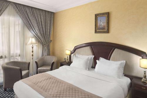 a hotel room with a bed and a window at Ramada By Wyndham Fes in Fès