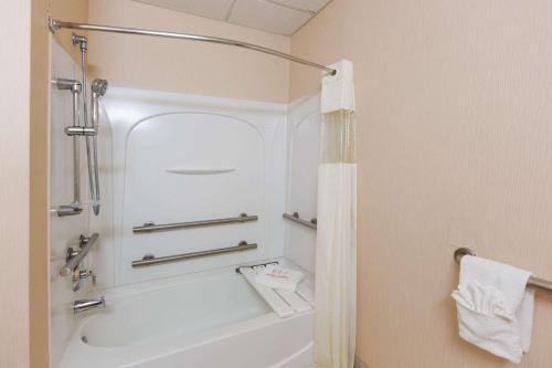 a bathroom with a white tub and a shower at Days Inn by Wyndham Budd Lake in Budd Lake