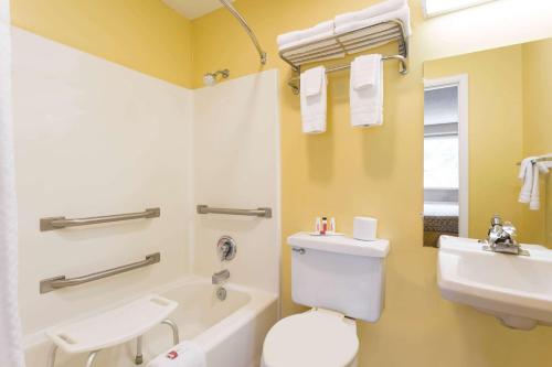 a bathroom with a white toilet and a sink at Days Inn by Wyndham Chincoteague Island in Chincoteague