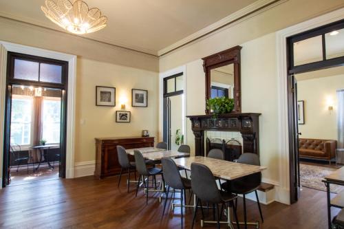 a dining room with a table and chairs and a fireplace at Hochelaga Inn in Kingston