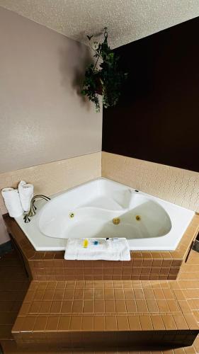 a large white bath tub in a bathroom at Super 8 by Wyndham North Platte in North Platte