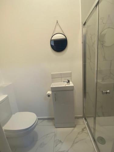 a bathroom with a toilet and a sink and a shower at Studio in bolton town, short stay studio 9 in Bolton
