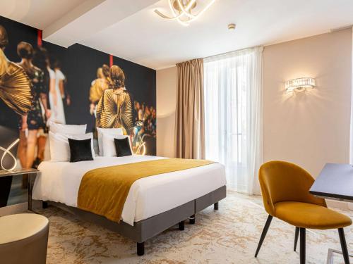 a hotel room with a bed and a painting on the wall at Mercure Paris Place d'Italie in Paris