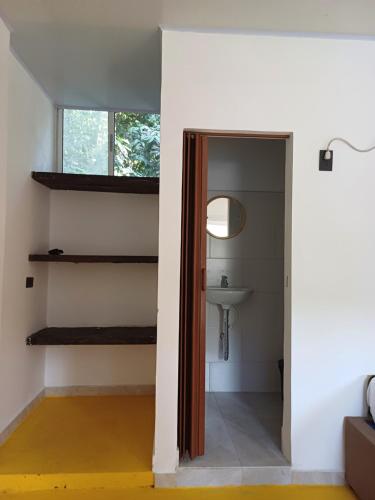 a bathroom with a sink and a staircase in a room at Finca LA CASCADA in Mesa del Norte
