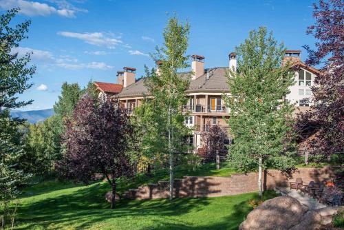 an exterior view of a large house with trees at Woodrun Place 11 in Snowmass